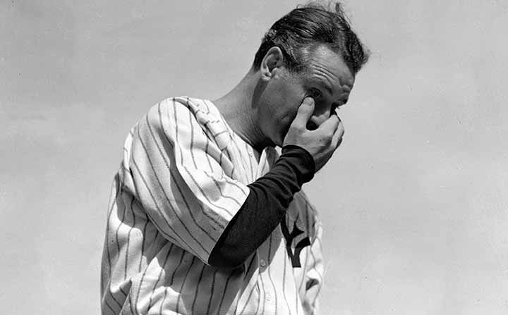 Lou Gehrig wipes away a tear while speaking during his retirement speech at a sold-out tribute at Yankee Stadium on July 4, 1939.